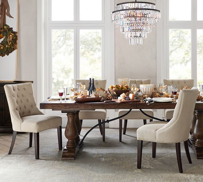 a dining room table with chairs and a chandelier