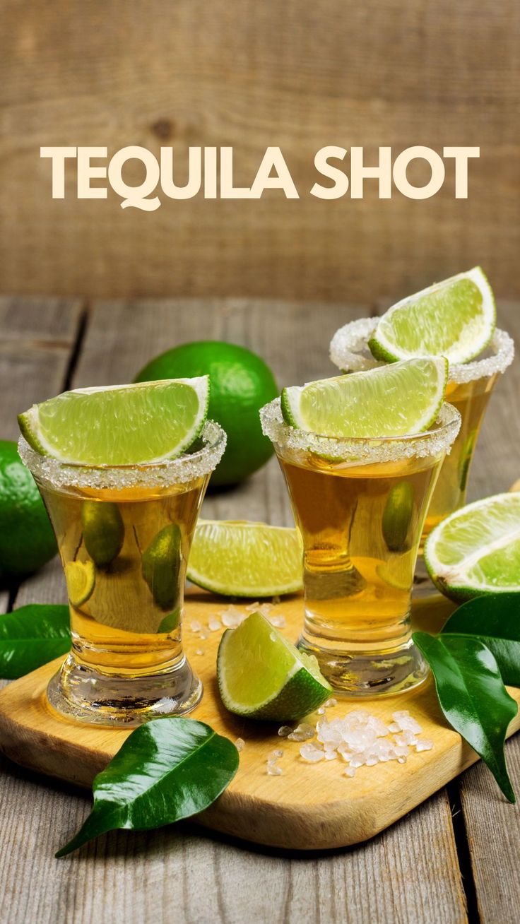 tequila shots on a cutting board with limes and leaves