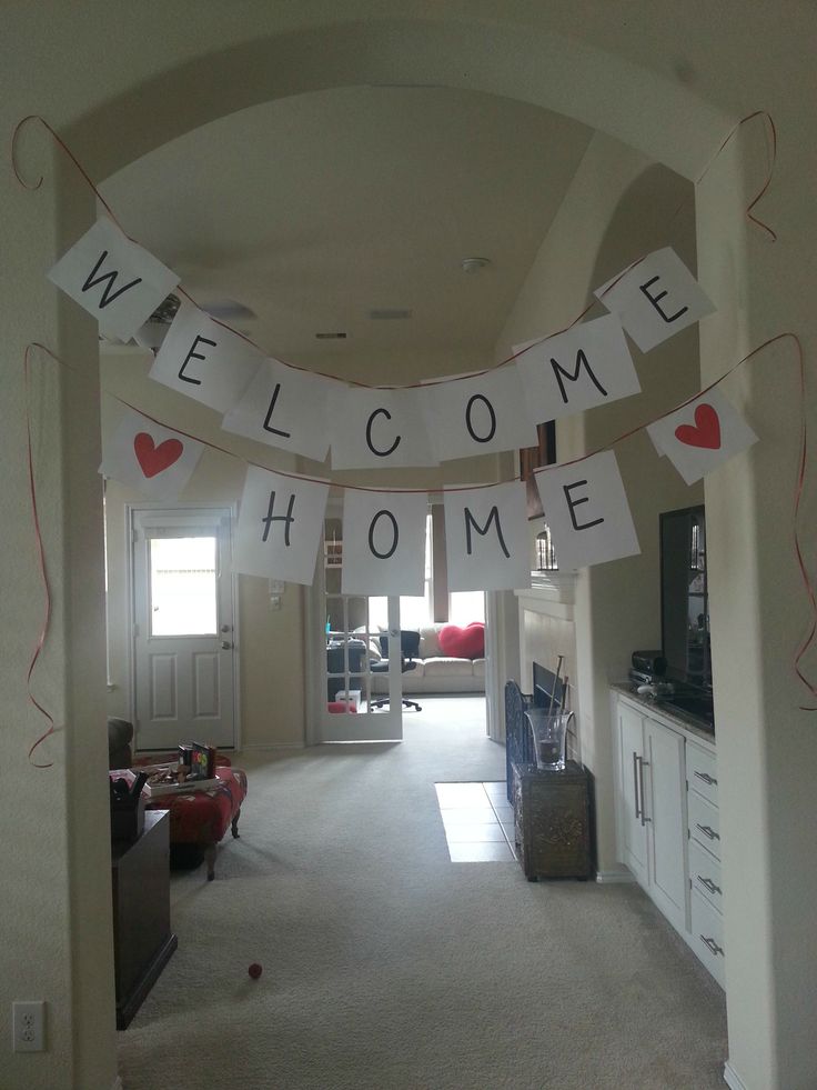 a welcome home banner hanging from the ceiling