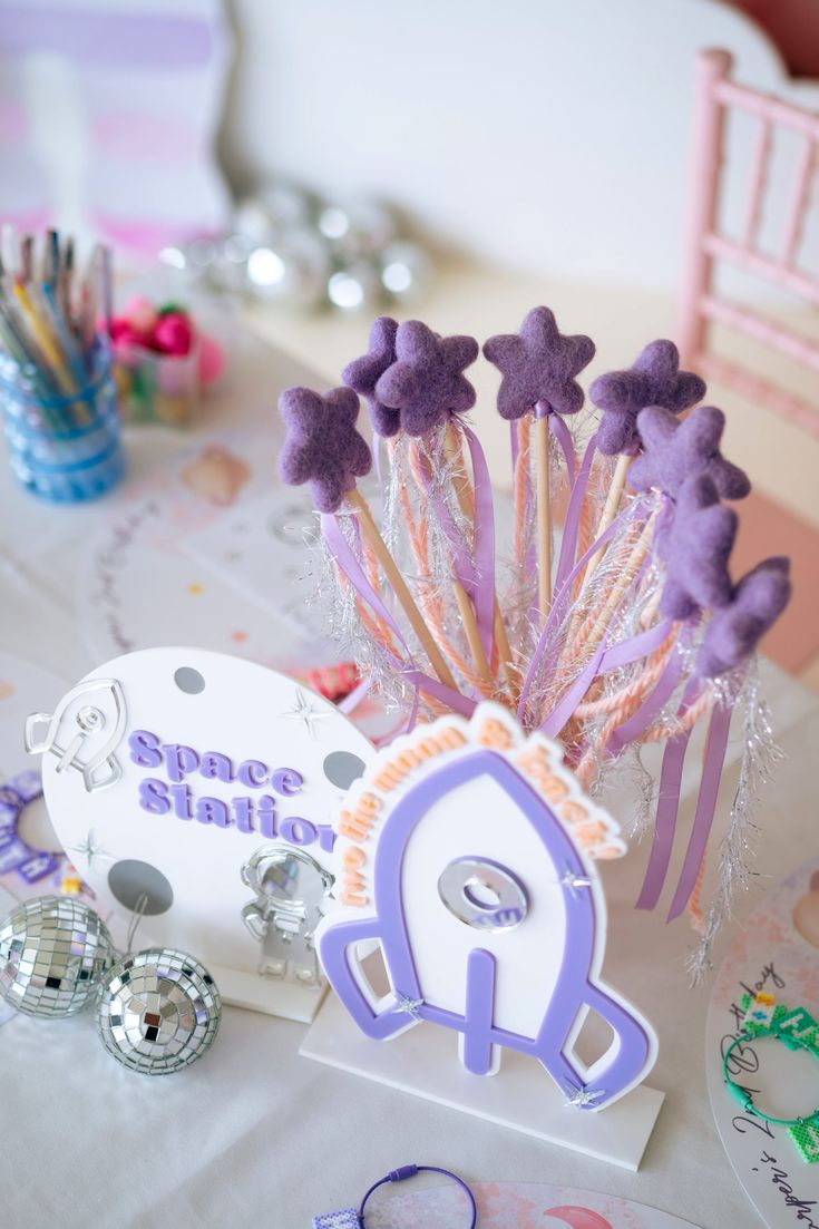 a table topped with purple and white decorations