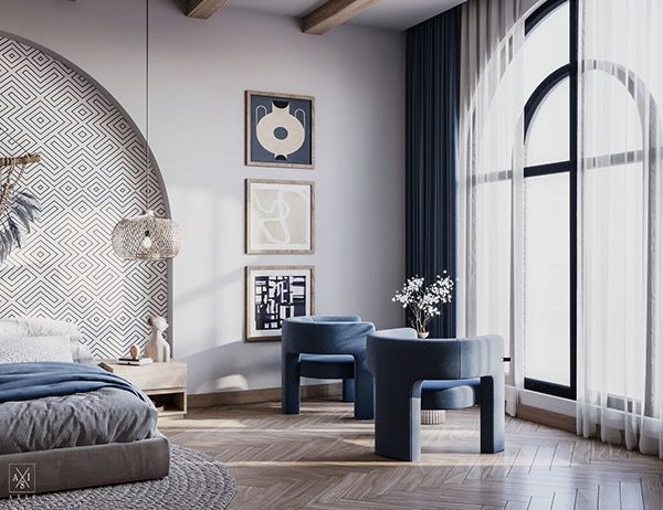 a bedroom with a bed, two stools and pictures on the wall above it