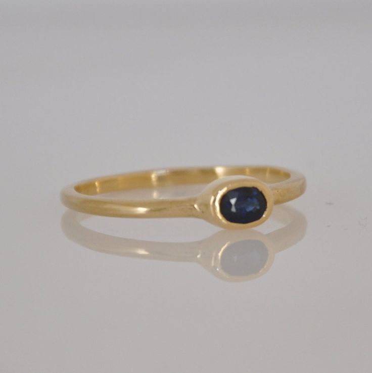 "This is a 18k gold Beautiful ring with a gentle oval blue Sapphire gemstone. That soliter ring is just the perfect stacking ring. Not too big and not too small. You can wear this ring every day and for every occasion. The blue Sapphire color is a perfect harmony with the 18k solid gold. This ring can be the center piece of a set of gold stacking rings. I can set diffrent color of gemstone in this gold ring. Dimensions: Oval Sapphire: 5 m\"m * 3 m\"m You can see other gemstone rings n my shop: h Gold Ring Stacking, Ring Blue Sapphire, Gold Sapphire Ring, Green Tourmaline Ring, Beautiful Wedding Rings, Blue Sapphire Ring, Solid Gold Ring, Etsy Gold Ring, Sapphire Color