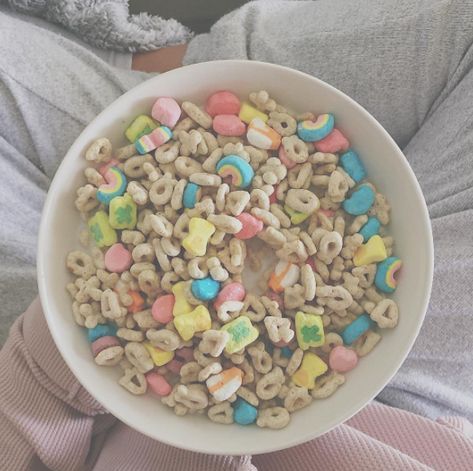 a white bowl filled with cereal on top of a person's lap