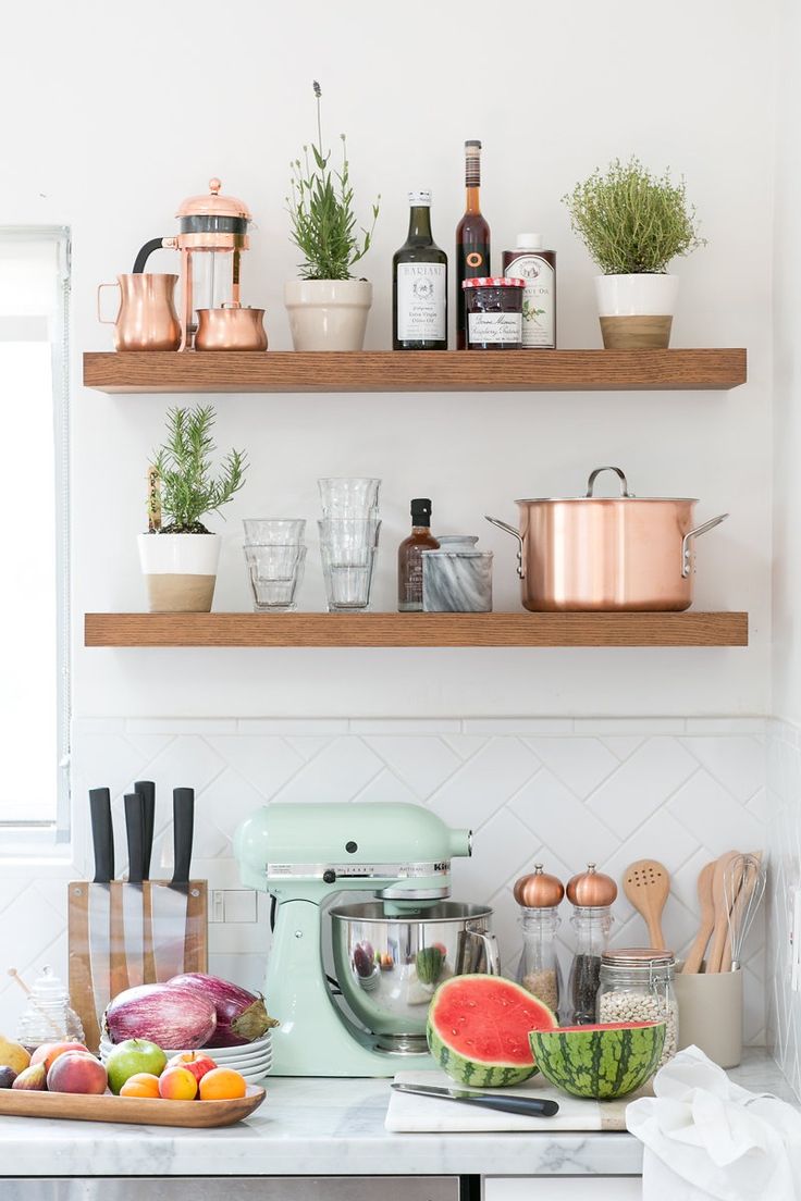 a kitchen counter with various fruits and vegetables on it, including watermelon, melon, radish