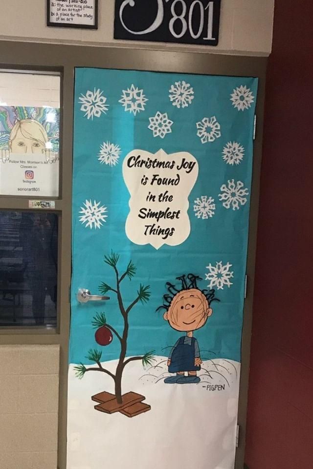 a door decorated with a charlie brown christmas tree