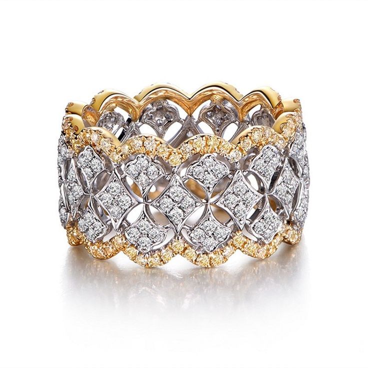 two tone gold and white diamond ring with an intricate design on the center, set in 18k yellow gold