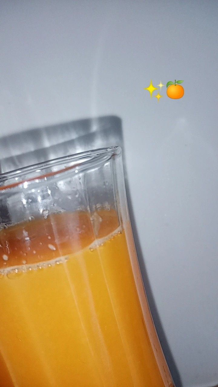 an orange juice in a blender on a table