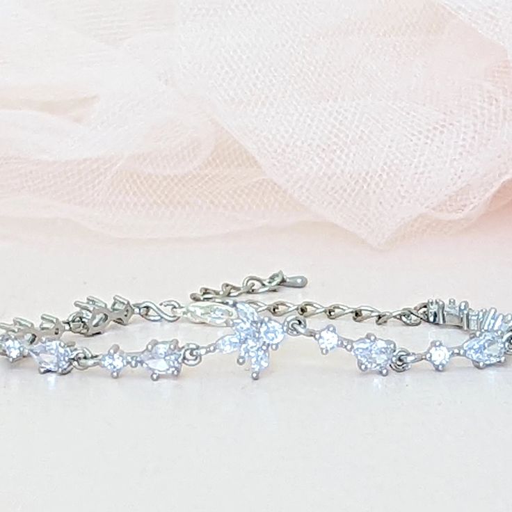 A single strand of diamonds will beautifully complement any wedding dress. Diamonds go with everything, just as lab diamonds go with every color.The CZ marquise will make a perfect finishing touch to your elegant look.DETAILS● Designed and handcrafted by ©JazzyAndGlitzy● This delicate drop and leaf-designed bridal bracelet feature AAA+A grade cubic zirconium.And the finish is with rhodium-plated silver or rose gold.● The bracelet measures 6 inches long + 2 inches extender chain.● Lead, nickel, a Dazzling Tennis Bracelet With Sparkling Stones For Wedding, Elegant Cubic Zirconia Crystal Bracelet With Diamond Cut, Elegant Cubic Zirconia Bracelet With Diamond Cut, Wedding Crystal Bracelet With Diamond Cut Cubic Zirconia, Elegant Diamond Cut Cubic Zirconia Crystal Bracelet, Elegant Sparkling Cubic Zirconia Wedding Ring, Wedding Bracelets With Sparkling Stones In Sterling Silver, Wedding Tennis Bracelet With Sparkling Cubic Zirconia, Wedding Tennis Bracelet With Sparkling Stones