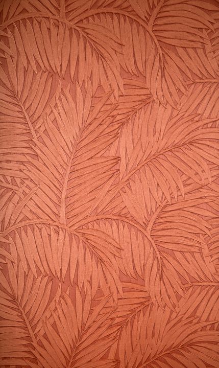 an orange wallpaper with palm leaves on it