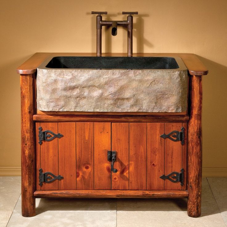 an old fashioned sink with two faucets on the side and a stone counter top