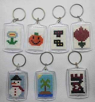 cross stitch keychains with different designs on them