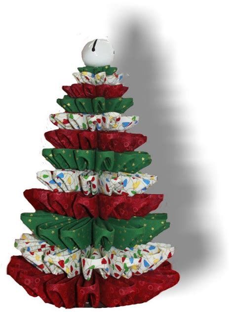 a christmas tree made out of wrapping paper with an apple sitting on top of it