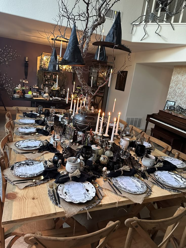 a dining room table is set with plates and candles