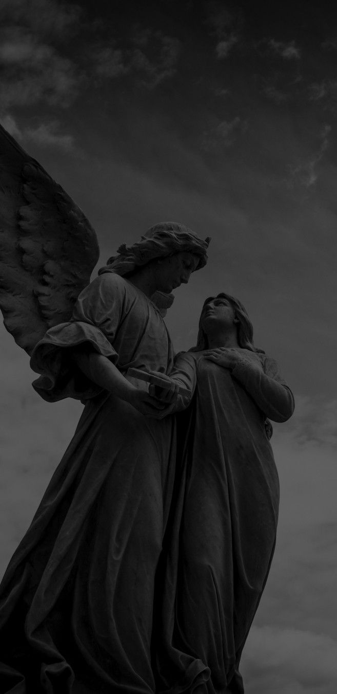 an angel statue with its arms around the back of it's head and wings