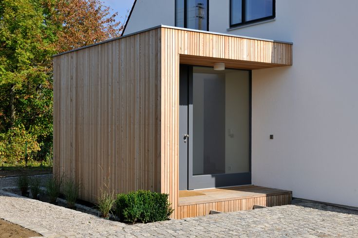 a small house with a wooden door and windows