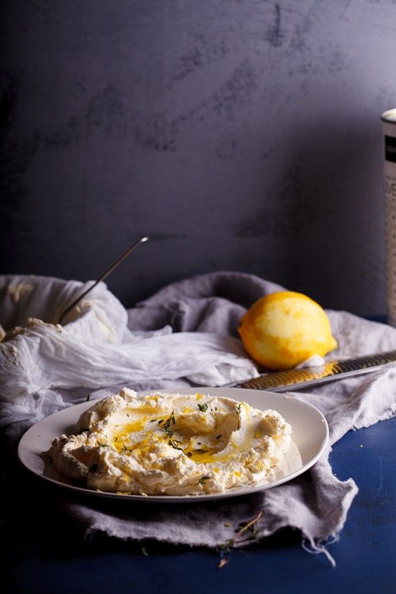 a plate with mashed potatoes and a jar of mustard next to it on a table