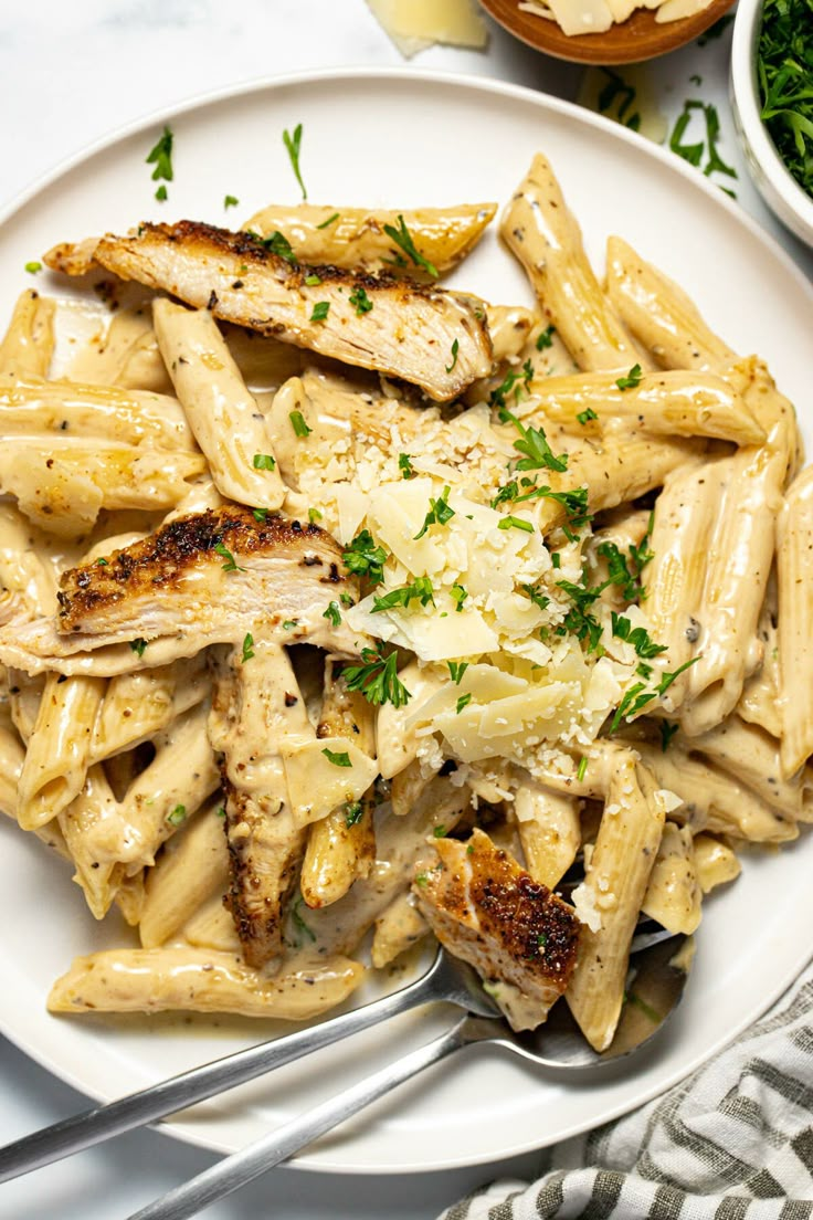 a white plate topped with pasta and chicken