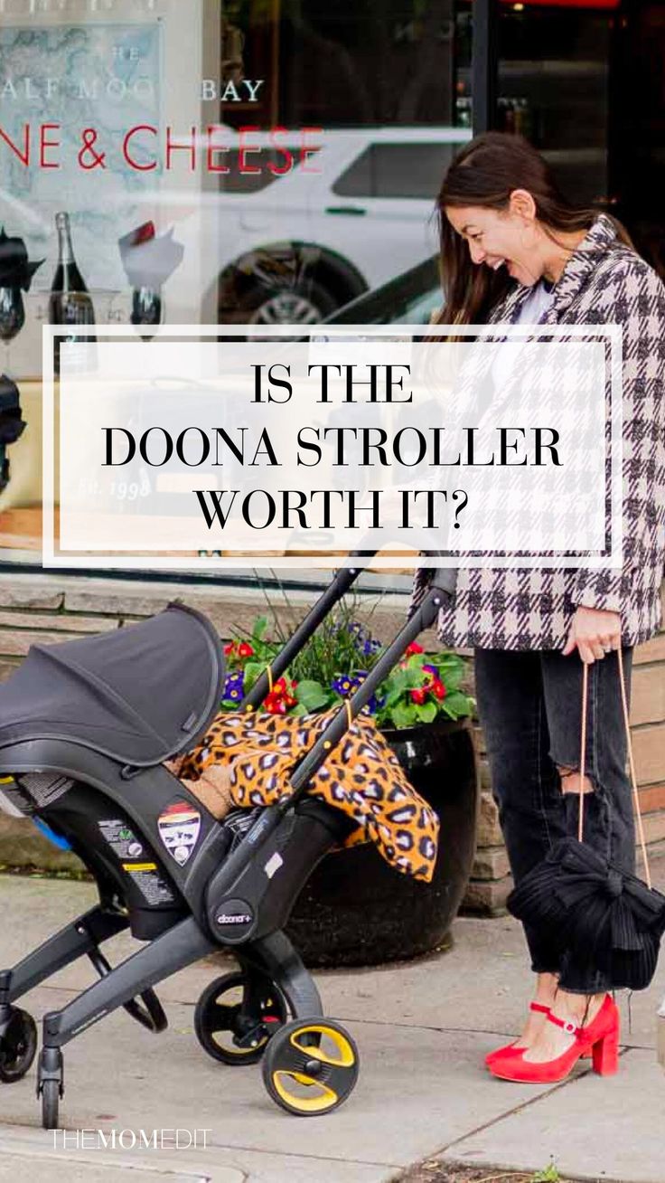 a woman standing next to a stroller with the words is the doona stroller worth it?