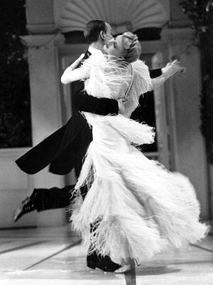 a man and woman dance together in an old fashion photo from the 1950's