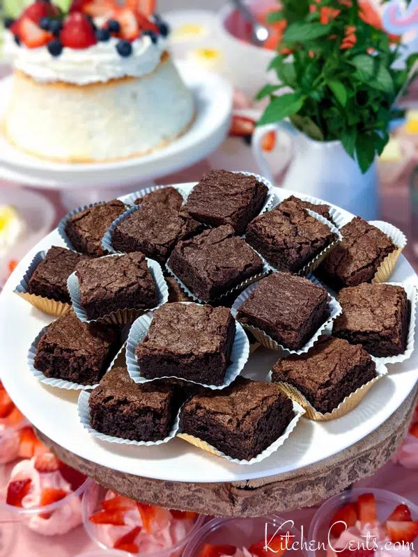 there are many cupcakes that are on the table with other desserts in the background