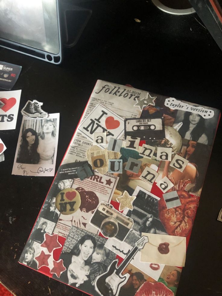 a table topped with pictures and stickers on top of it's surface next to a laptop computer