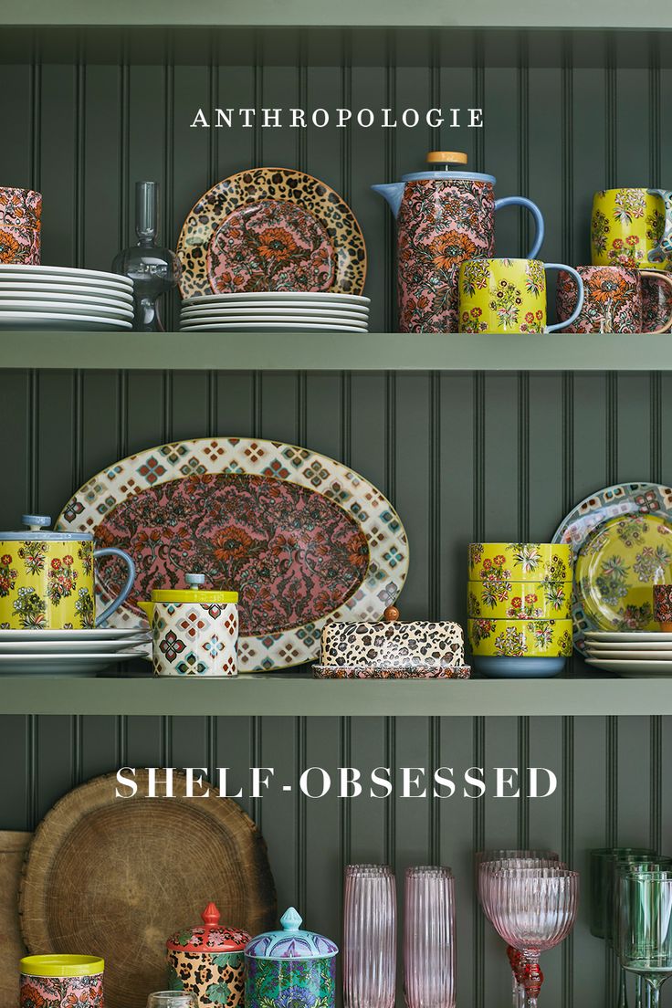 the shelves are filled with colorful dishes and cups