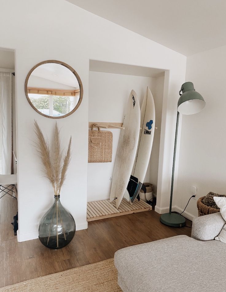 a living room with two surfboards on the wall