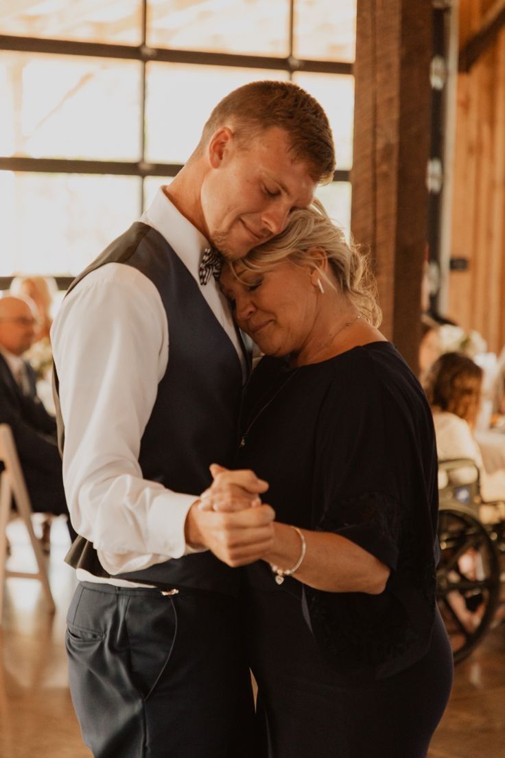 a man and woman dance together at a wedding