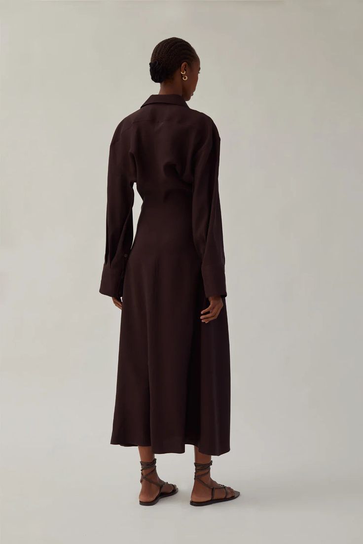 Heirlome's Pia Dress is a long-sleeved, button down midi length dress in silk shantung with bias draped bodice. Silhouette is fitted at waist with a flared hem, details include shirt collar and cuffs at sleeves. Product Details Designer ID: HL-IV-0430 Color: Dark Chocolate Composition: 100% Silk Imported Semi-formal Long Sleeve Viscose Dress, Long Sleeve Silk Dress For Work, Chic Long Sleeve Silk Dress For Work, Semi-formal Long Sleeve Satin Dress, Chic Silk Long Sleeve Dress For Fall, Long Sleeve Silk Dress For Daywear, Fall Semi-formal Satin Dress, Fitted Viscose Silk Dress For Workwear, Classic Long Sleeve Silk Dress