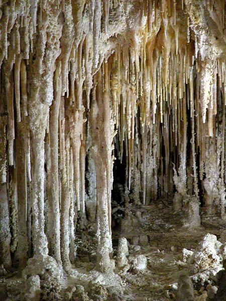 the inside of a cave with icicles hanging from it