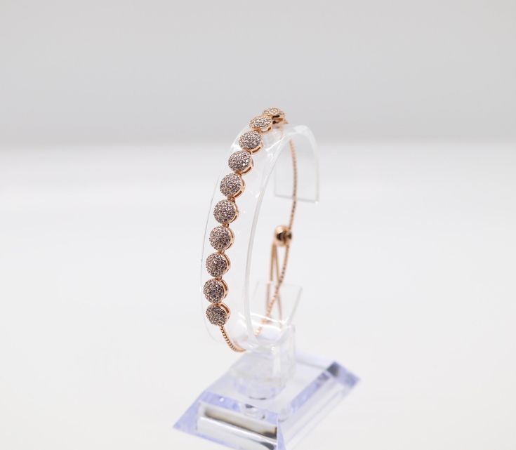 This bracelet is made of rose gold, which is a beautiful and durable material. The bracelet is designed to be worn by women and is available in a variety of sizes to ensure a comfortable fit. The bracelet is adorned with a delicate pattern that adds a touch of elegance to any outfit. Elegant Rose Colored Bracelet Jewelry, Elegant Rose-colored Bracelet Jewelry, Rose Gold Charm Bracelet With Jubilee Detail, Rose Gold Charm Bracelet With Jubilee Bracelet, Rose Gold Jubilee Charm Bracelet, Adjustable Rose Gold Diamond Bangle, Adjustable Rose Gold Jubilee Diamond Bracelet, Adjustable Rose Gold Charm Bracelet For Parties, Rose Gold Chain Bracelet With Bracelet Strap