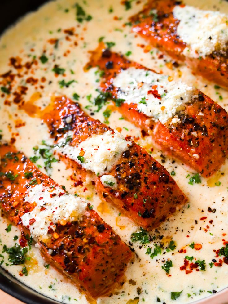 several pieces of meat with sauce and parmesan cheese