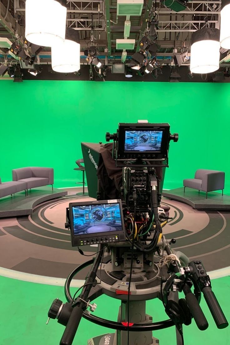 a camera set up in front of a green screen