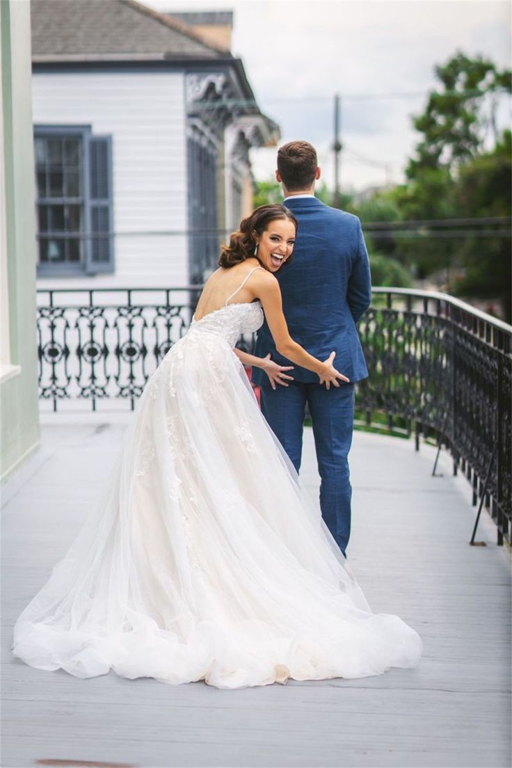 the bride and groom are walking down the sidewalk