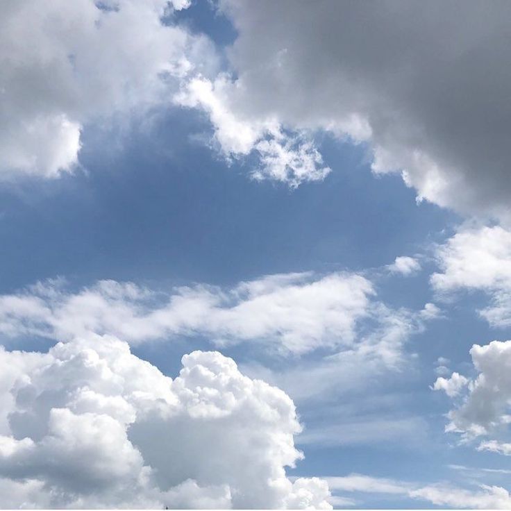 an airplane is flying through the cloudy sky