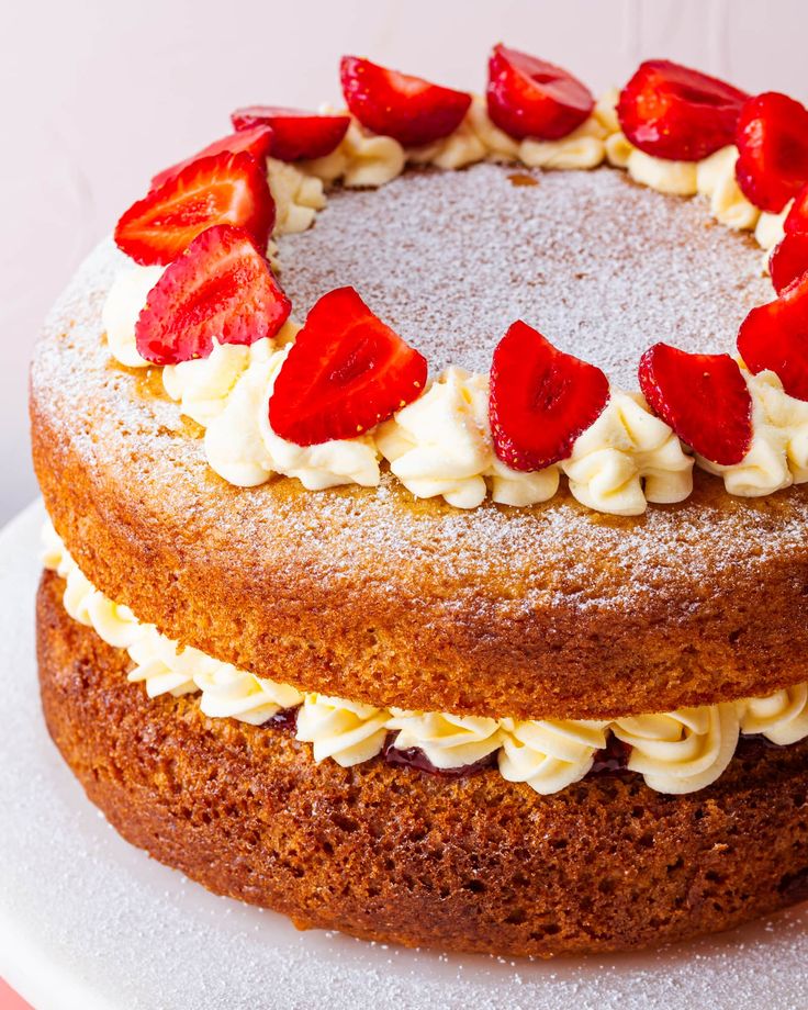 a cake with strawberries on top is sitting on a plate