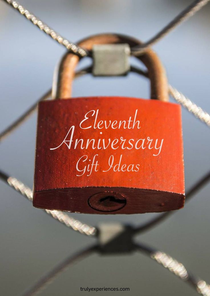 a red padlock attached to a chain link fence with the words, seventh anniversary gift ideas written on it