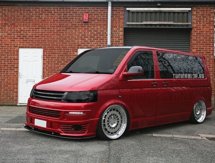 a red van parked in front of a brick building