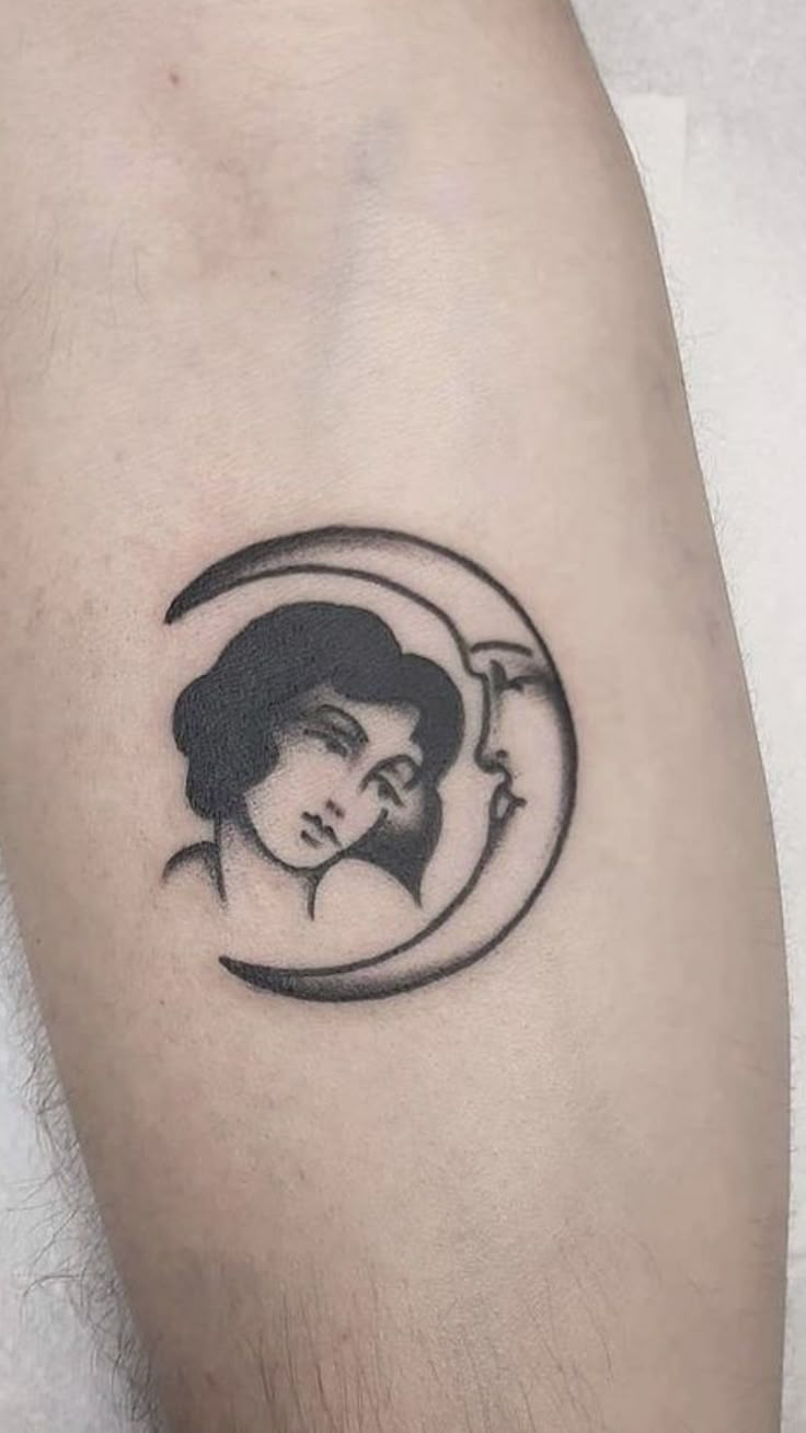 a woman's face with a crescent tattoo on the arm