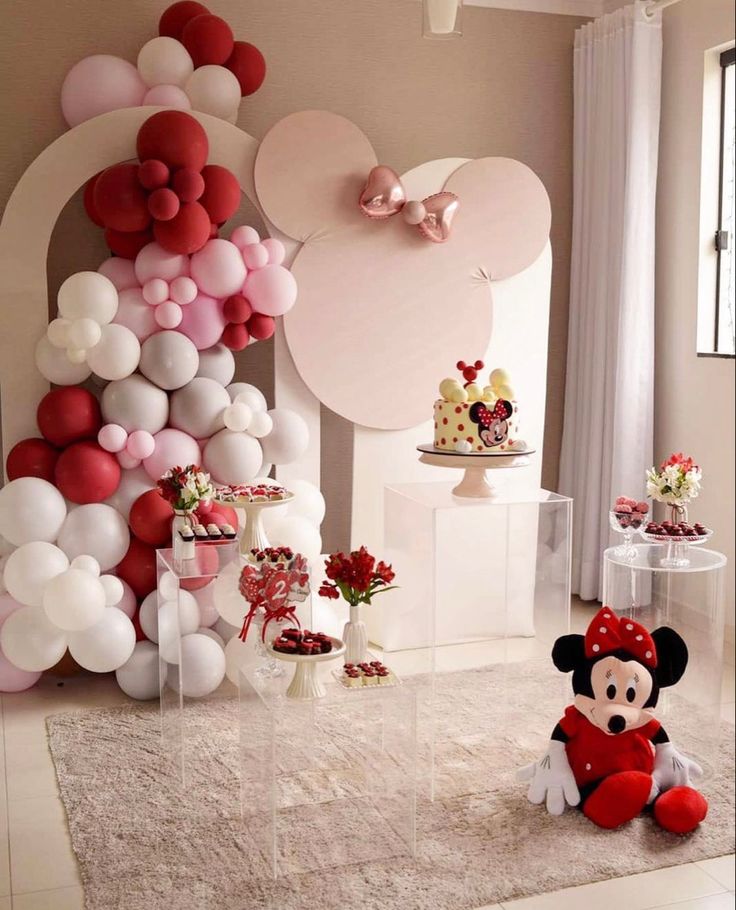 a room with balloons and minnie mouse decorations