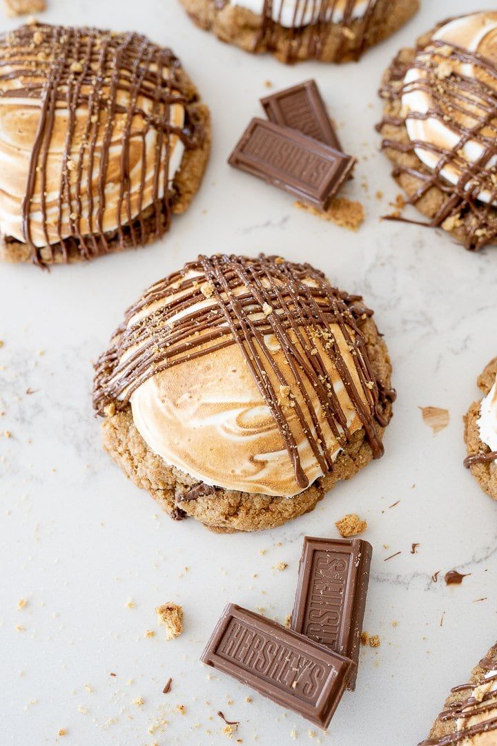 some cookies with chocolate and marshmallow frosting on them are sitting next to each other