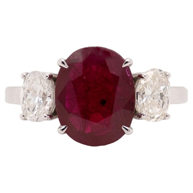 an oval ruby and diamond three stone ring