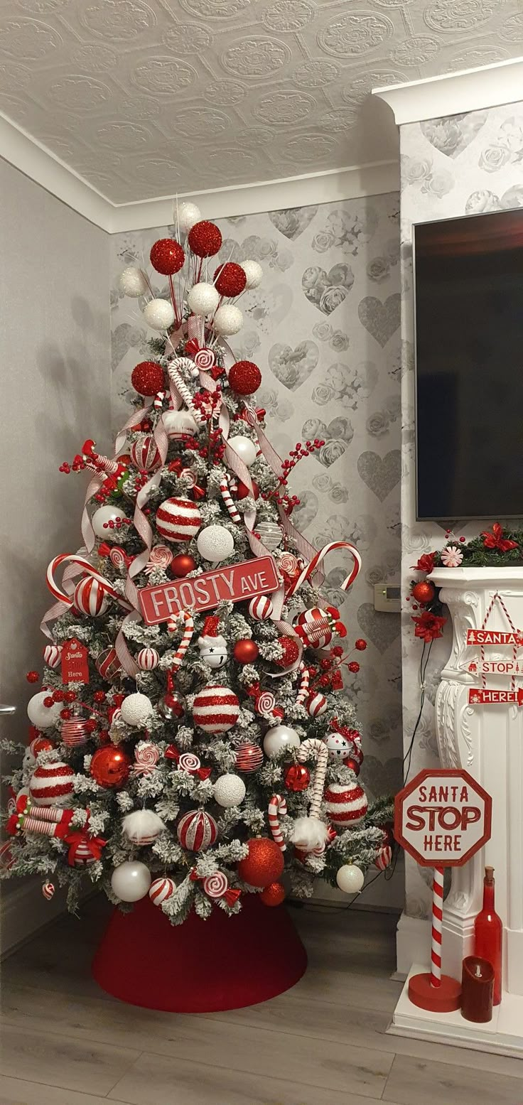 a decorated christmas tree with candy canes and ornaments in red, white and silver