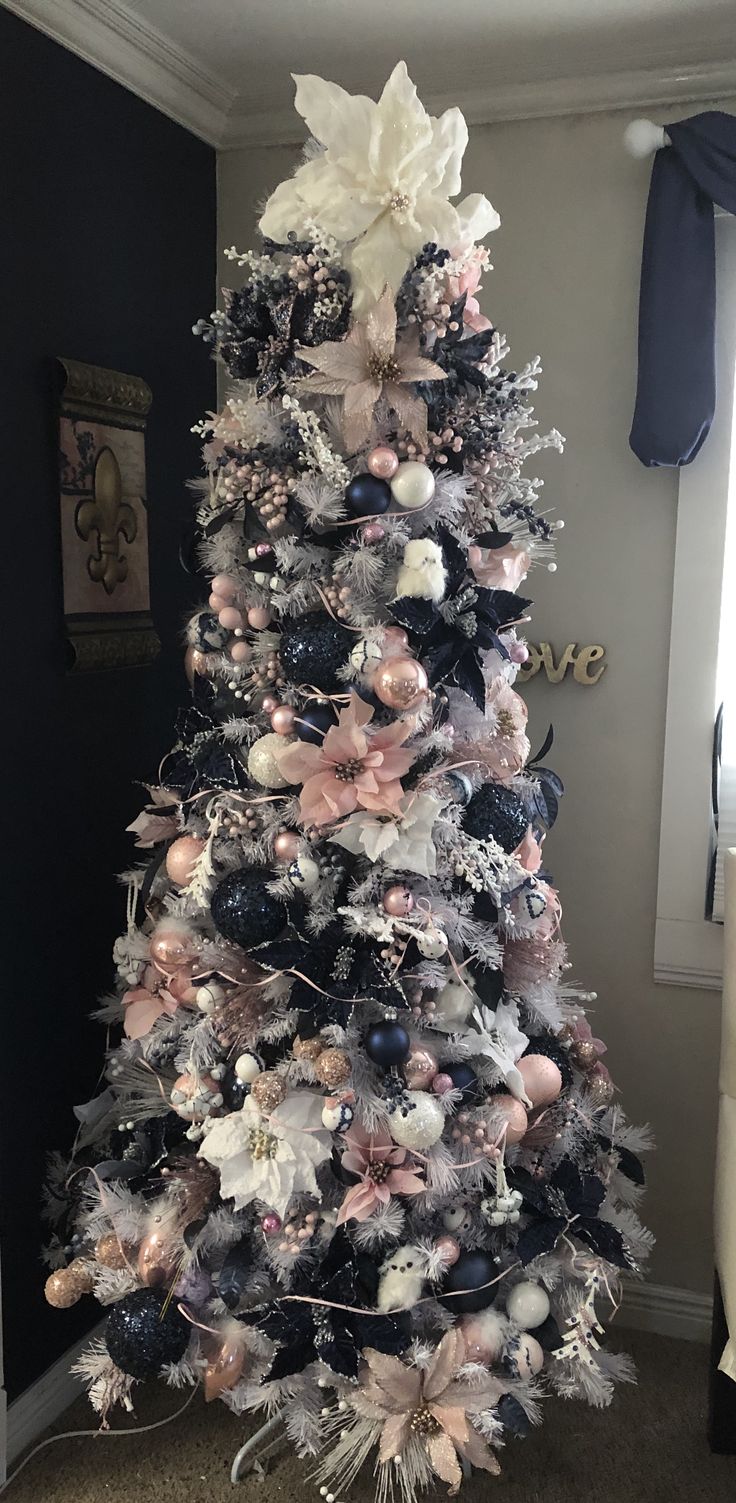 a christmas tree decorated with black, white and pink ornaments