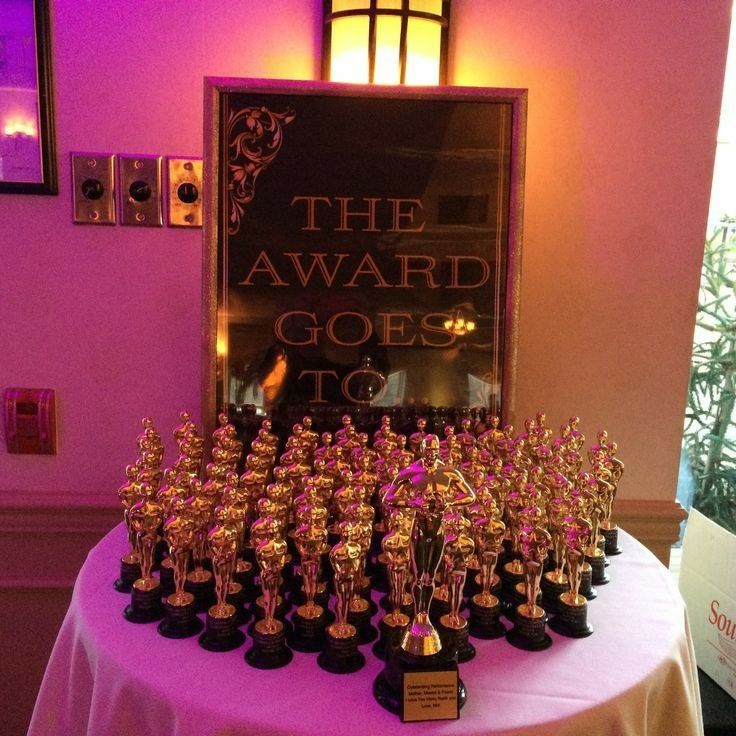 the award goes to many small figurines sitting on top of a round table