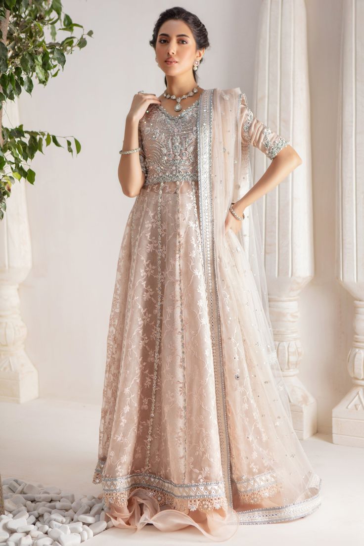 Step up your festive dressing game with our beautifully crafted kalidar over a canvas of stunning embroidered organza, heavily embellished with sequins, beads, crystals, neckline and sleeves beautifully adorned with gorgeous zardozi, mirror work & Resham thread work. Stunning hand-made stylized tassel details at back. This stunning multi panel kalidar is offset with jamawar Lehanga with gorgeous ruffle details & net dupatta featuring sequins & mirror motifs and chan, trimmed with mirror embroidered borders , a Must- have wardrobe staple to carry all Wedding Festivities in effortless style. Shirt Fabric: Pure embroidered Organza & Silk Net Lehanga Fabric: Jamawar Dupatta Fabric: French Net Color: Shell Pink This outfit is only available in Custom size, once order is placed design team will Reception Anarkali Set With Dabka Work For Navratri, Chandbali Anarkali Set With Mirror Work For Reception, Anarkali Dupatta With Mirror Work For Eid, Anarkali Choli With Mirror Work For Eid, Festive Anarkali Choli With Dabka Work, Festive Georgette Anarkali Set With Mirror Work, Festive Anarkali Set With Mirror Work In Georgette, Designer Anarkali Choli With Sheer Dupatta, Semi-stitched Anarkali Set With Mirror Work For Designer Wear