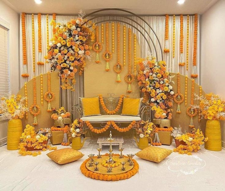 an orange and yellow wedding set up with flowers