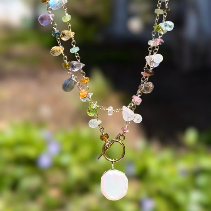 Semi-precious stones including garnet, rose quartz, citrine, peridot, sky blue topaz, amethyst, labradorite and moonstone are hand-wrapped in 14k gold dipped sterling silver with a keshi pearl charm.  Toggle closure designed to wear in front, 18" total length and layers beautifully with our Wildflower Choker.  Elegant, Spiritual Moonstone Jewelry With Gemstone Beads, Gold Multi-stone Moonstone Jewelry, Spiritual Sterling Silver Jewelry With Gemstone Beads, Moonstone Gemstone Beads Jewelry For Healing, Gold Moonstone Jewelry With Gemstone Beads, Sterling Silver Gemstone Beads Jewelry For Healing, Healing Sterling Silver Jewelry With Gemstone Beads, Healing Sterling Silver Gemstone Beads Jewelry, Dainty Jewelry With Natural Stones For Healing