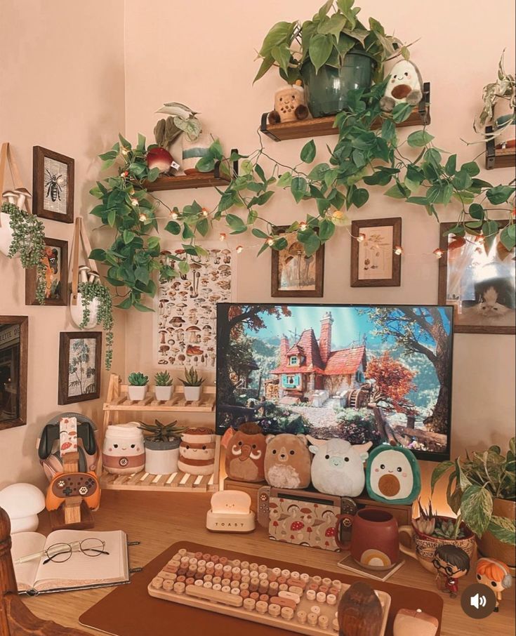 a computer desk topped with lots of stuffed animals and other stuff on top of it