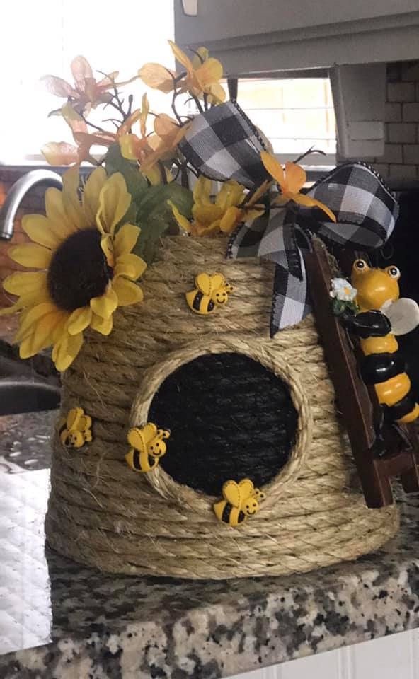 sunflowers and bees decorate the top of a basket